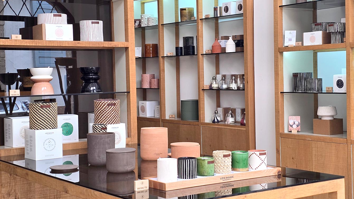 Intérieur de la boutique Côté Bougie à Essaouira : bougies parfumées dans leurs pots en céramique, raffia et grès