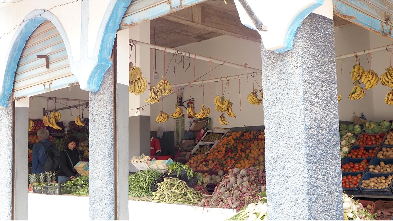 Le marché aux fruits et légumes sous les arcades.