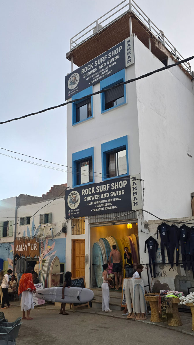 Boutique de surf Rock Surf Shop dans une ruelle du village de Taghazout, planches exposées devant la façade.